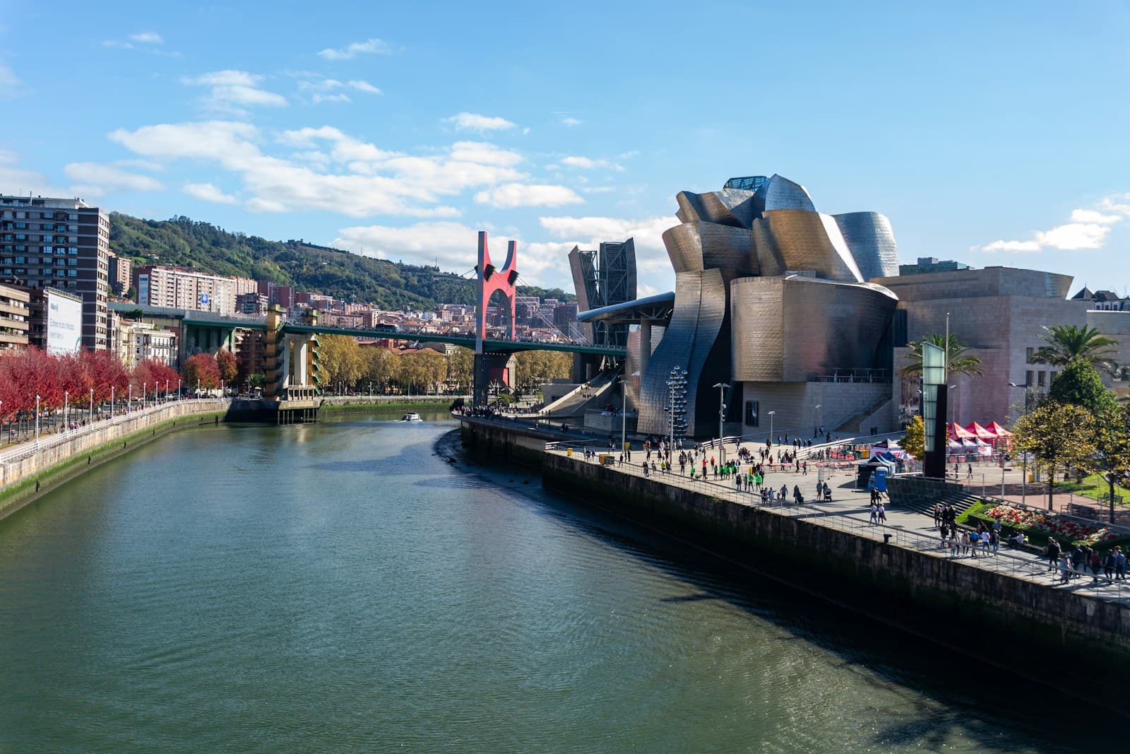 Bilbao: a river running through a city next to a bridge