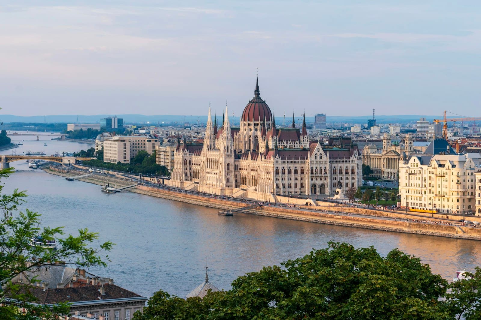 Budapest: brown concrete building near body of water during daytime