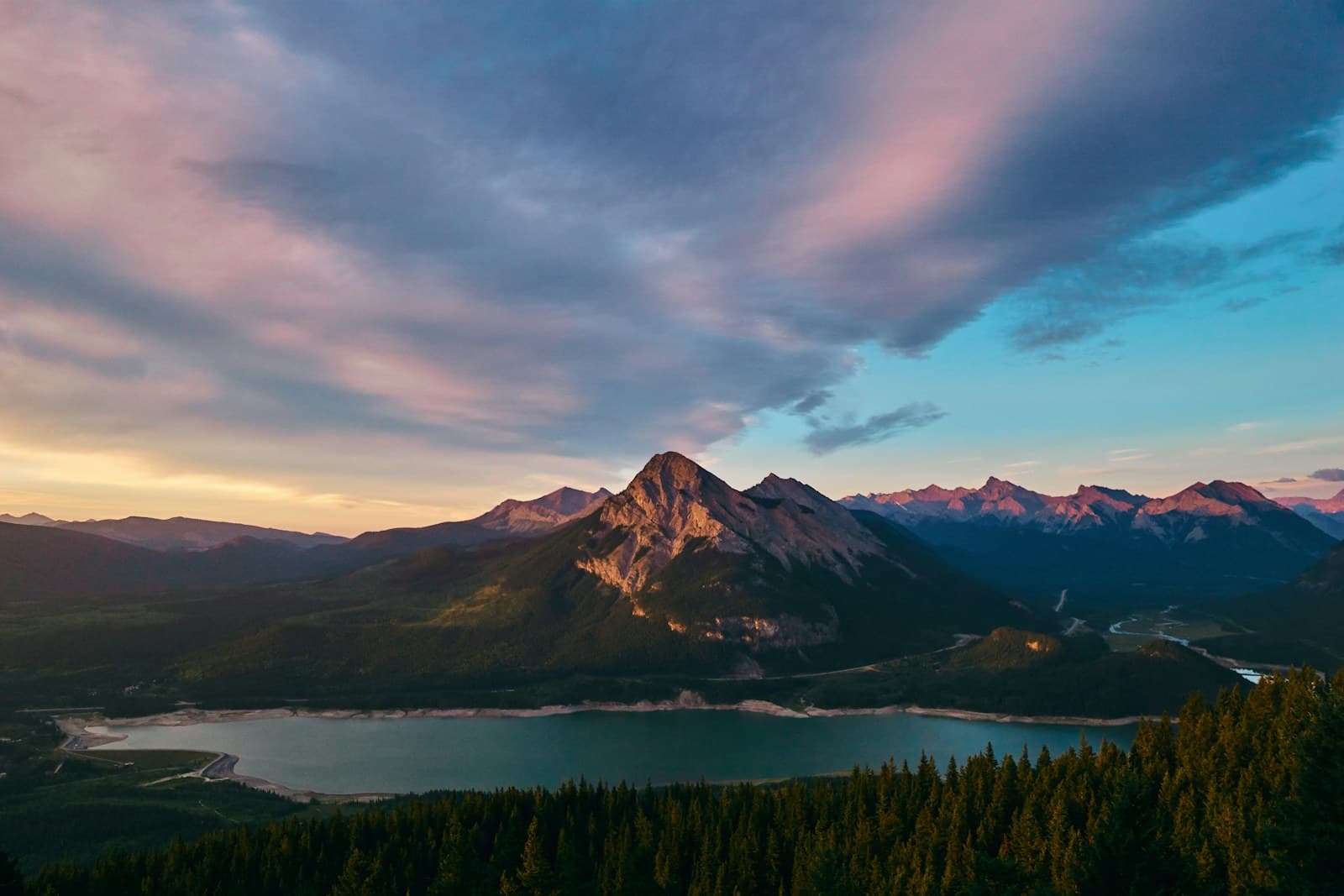 Canada: green trees near mountain under cloudy sky during daytime