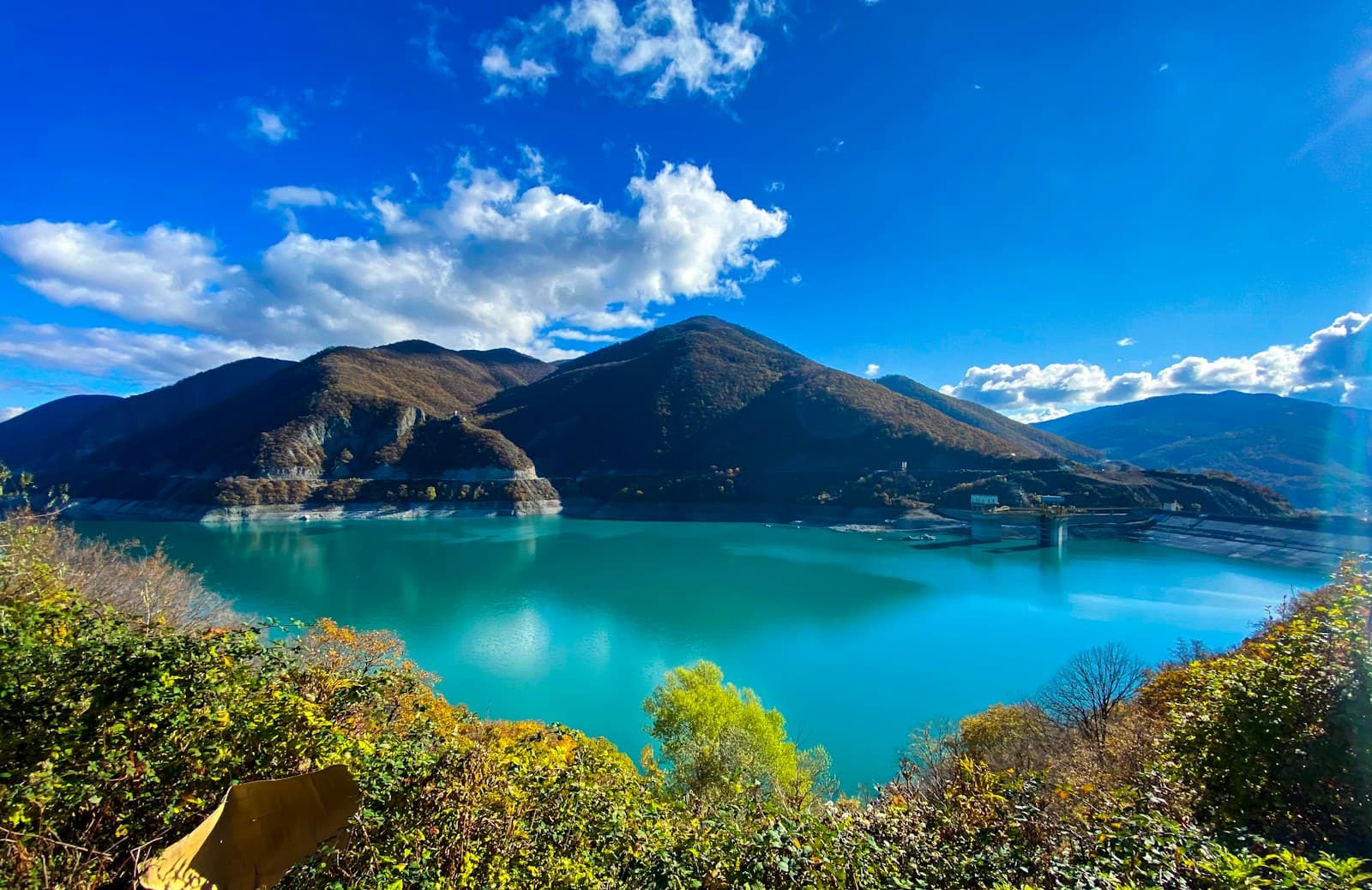 Georgia: lake surrounded by green trees and mountains under blue sky during daytime