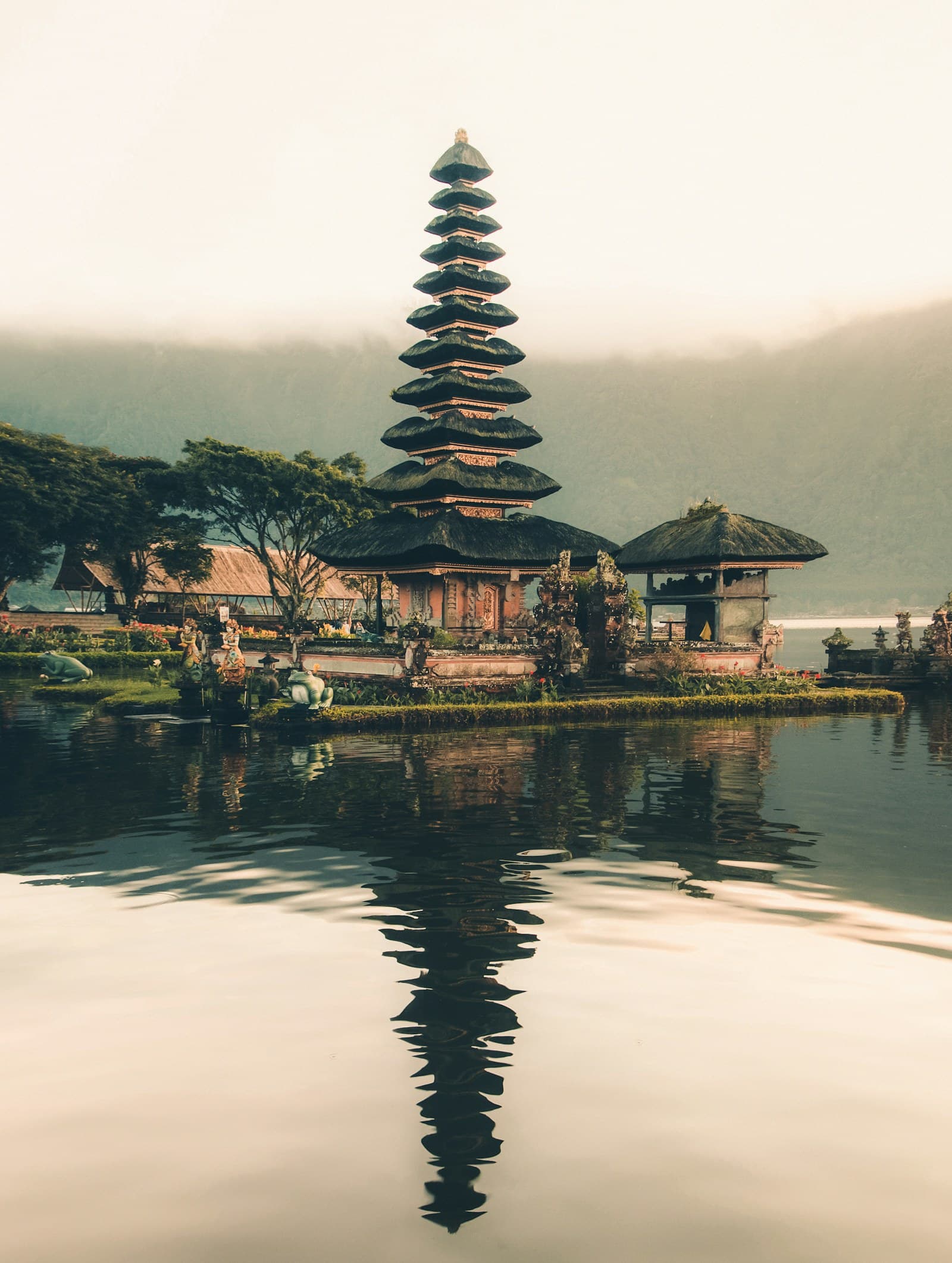 Indonesia: temple beside body of water and trees