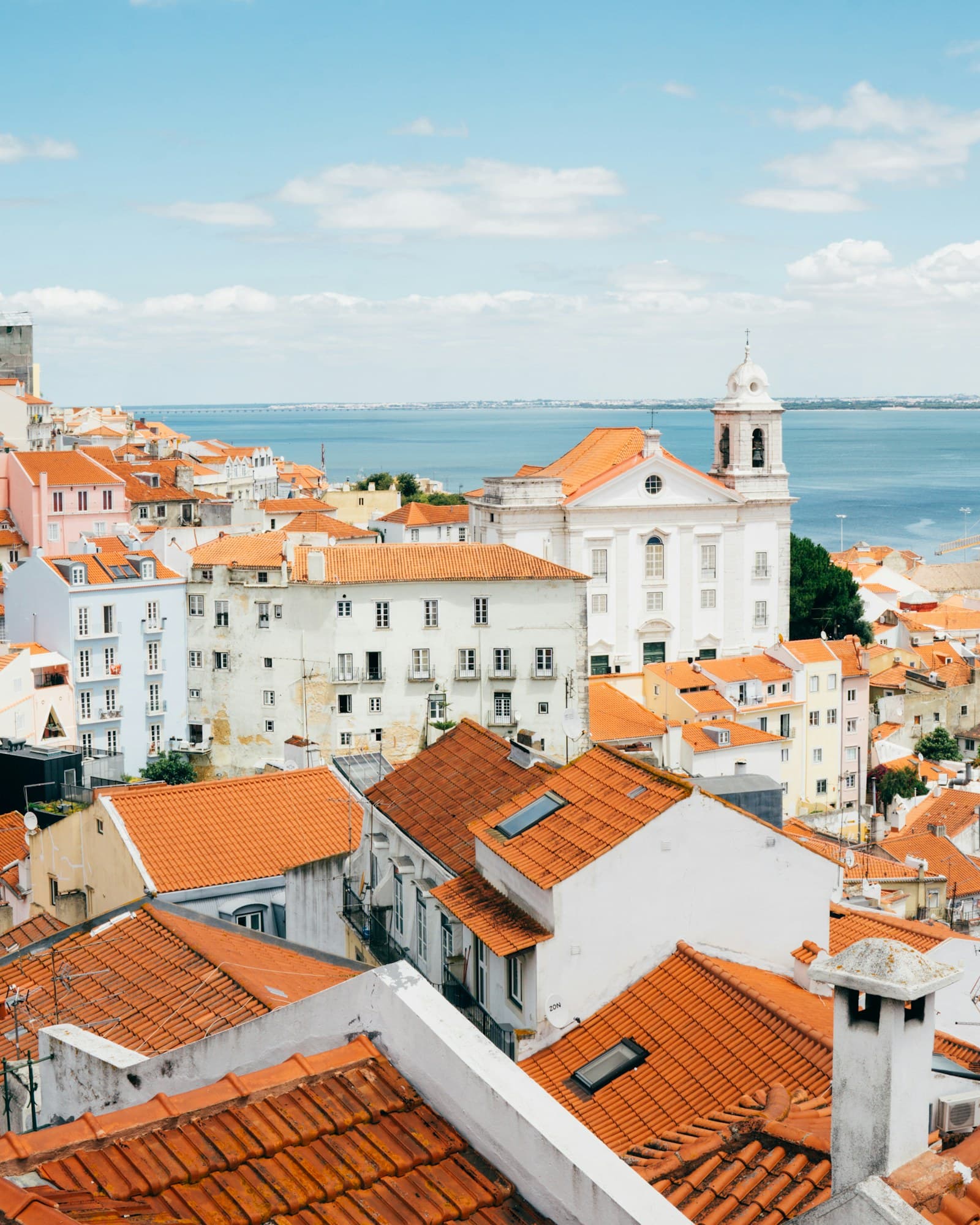 Lisbon: landscape photography of orange roof houses near body of water