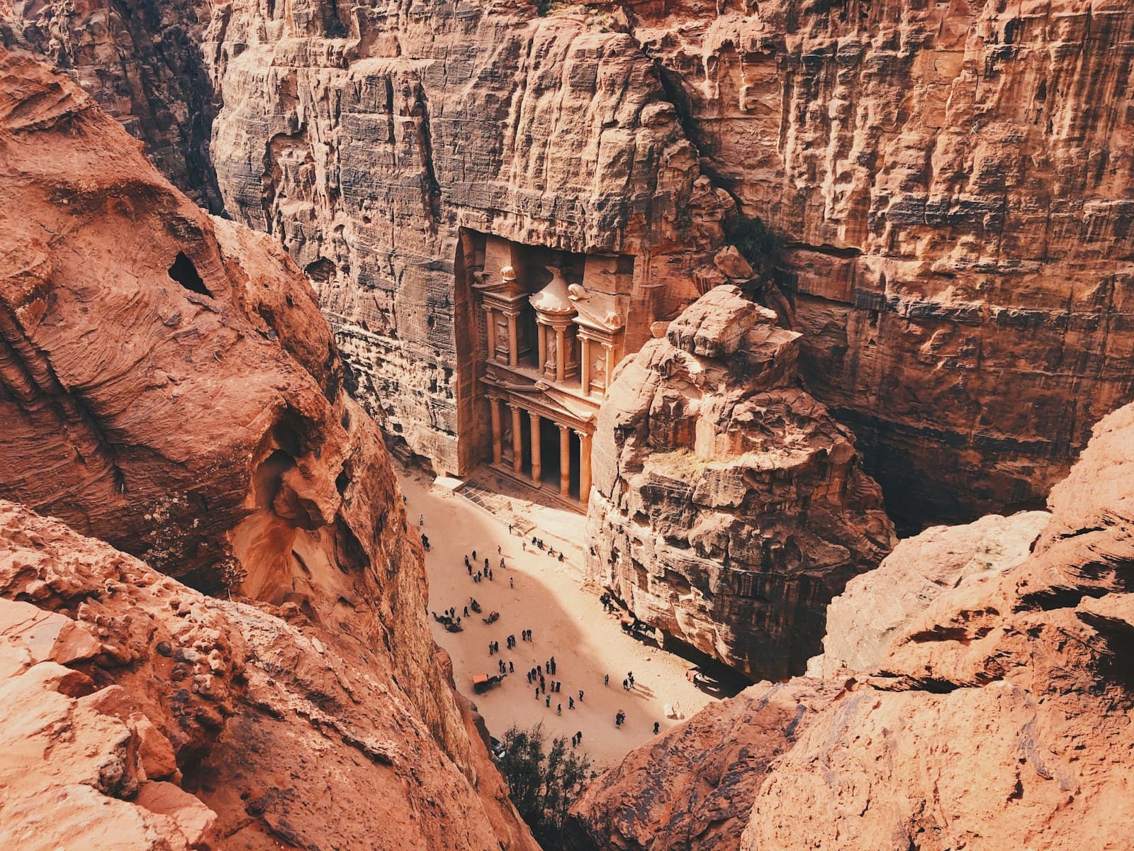 Jordan: brown and white concrete building on brown rocky mountain during daytime