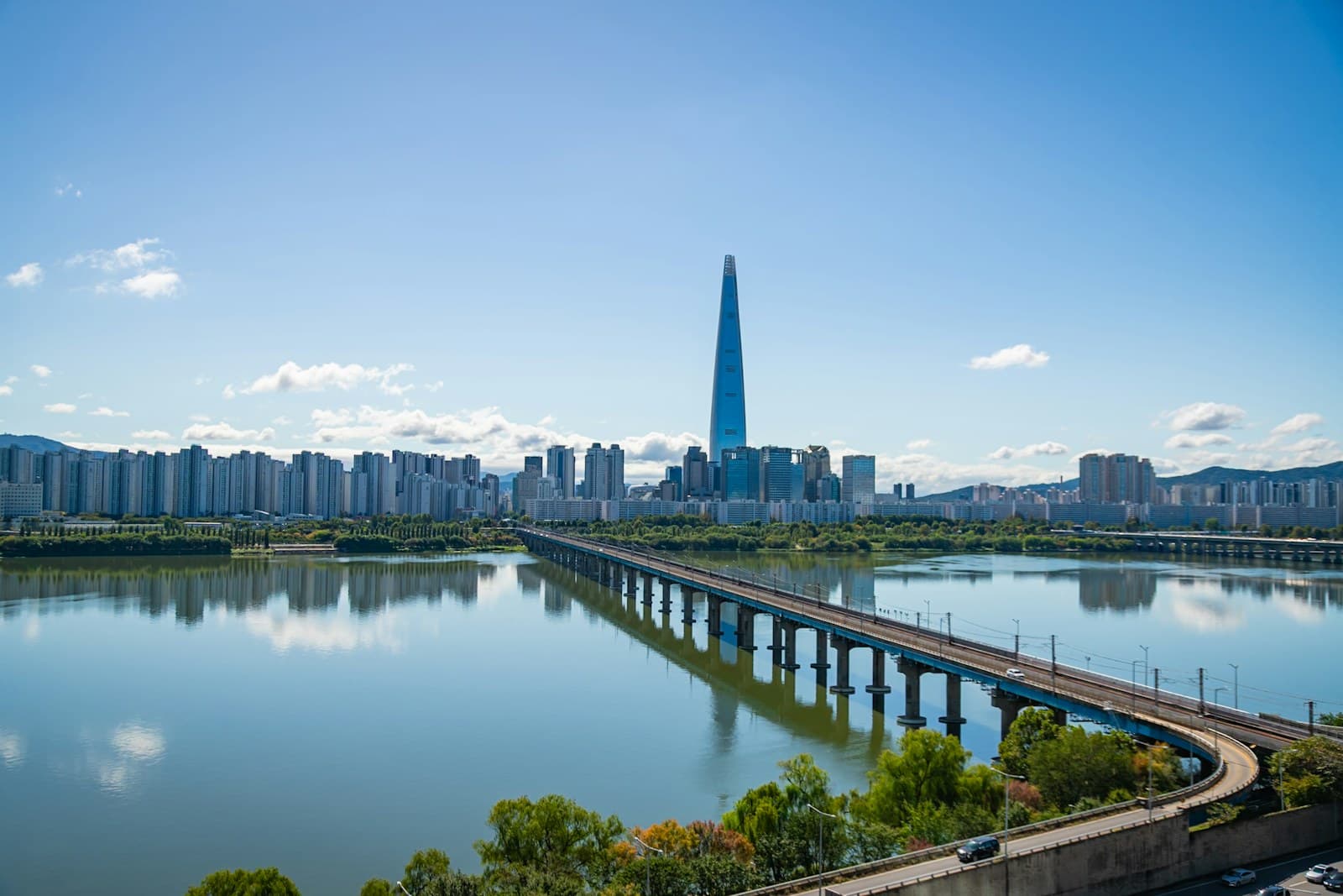 South Korea: Modern cityscape with a tall skyscraper and bridge over river