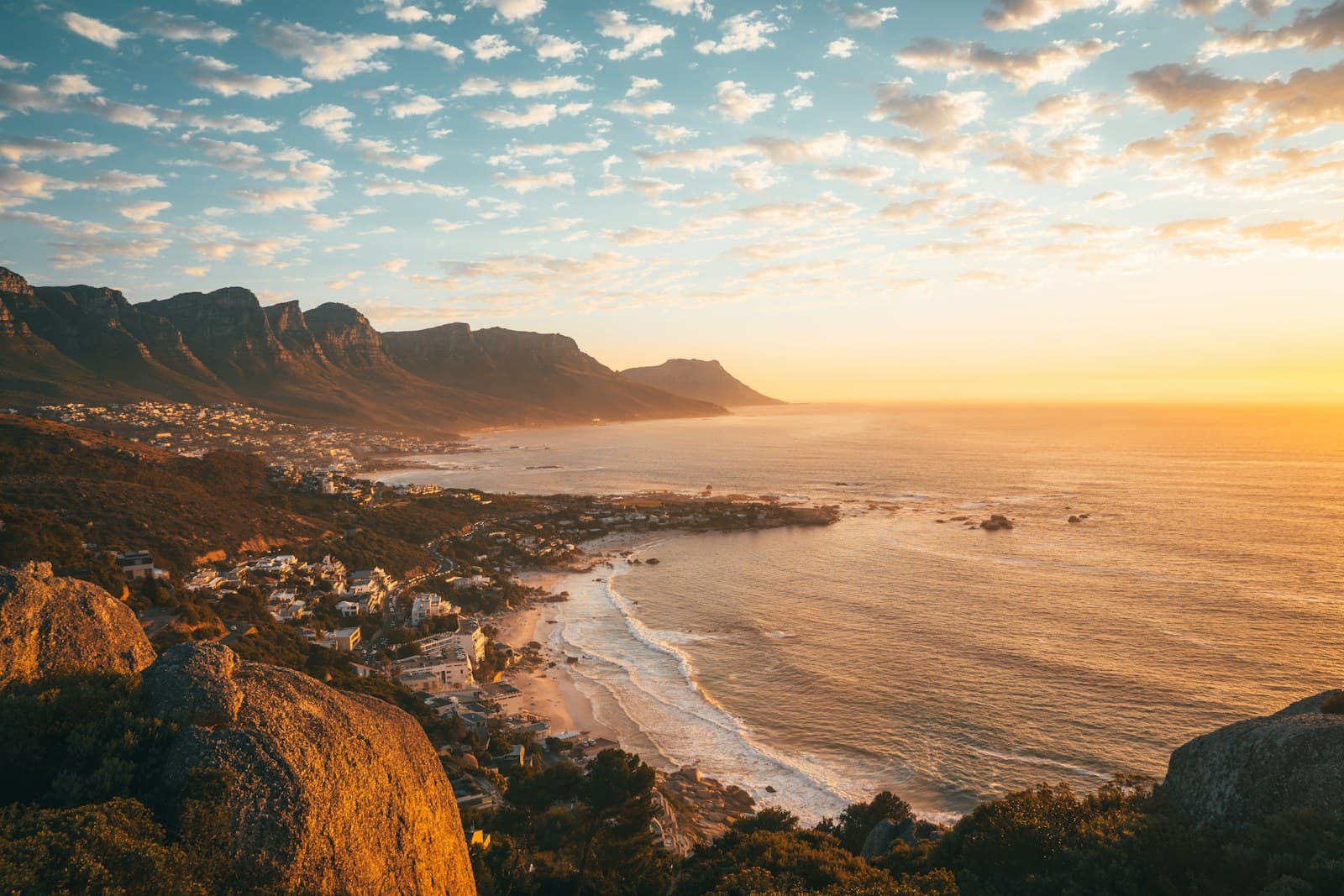 South Africa: brown rocky mountain beside sea during daytime